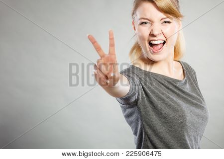 Celebration Communication Success Concept. Cheerful Lady Makes V Gesture. Young Girl Showing Peace S