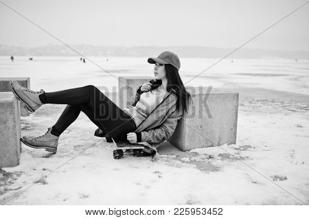 Stylish Brunette Girl In Gray Cap, Casual Street Style With Skate Board On Winter Day.