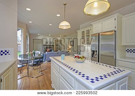 Spacious White Kitchen Interior With Kitchen Island.