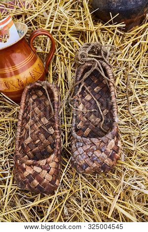 Bast Shoes On The Straw At The Souvenir Market. Traditional Shoes In Russia.