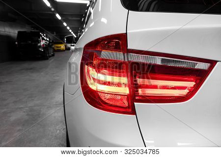 Macro View Of Modern  Car Xenon Lamp Headlight, Bumper, Wheel. Exterior Of A Modern Car