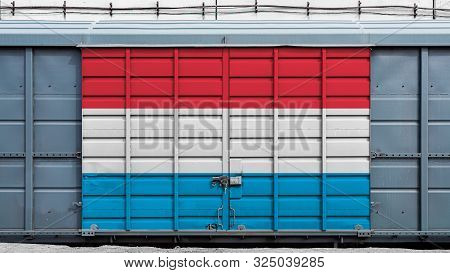 Front View Of A Container Train Freight Car With A Large Metal Lock With The National Flag Of Luxemb