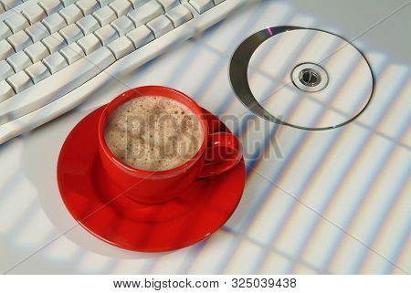 Cup Of Coffee, Dcs And Keyboard On A Studio Background