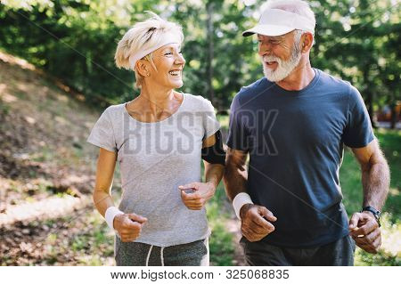 Happy Senior People Running To Stay Helathy And Lose Weight