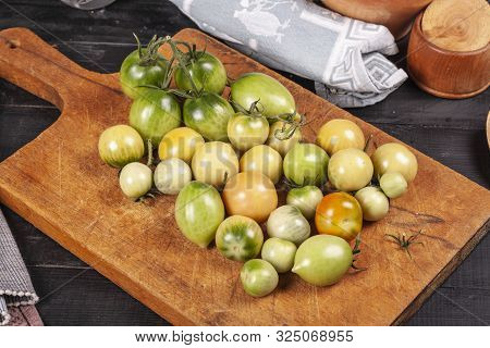Green Fresh Tomato On A Wooden Kitchen Board, Vegetarian Food, Healthy Nutrition, Fresh Tomatoes