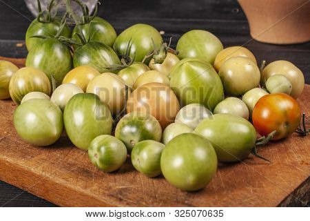 Green Fresh Tomato On A Wooden Kitchen Board, Vegetarian Food, Healthy Nutrition, Fresh Tomatoes
