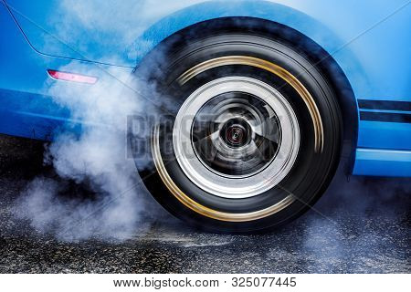 Drifting Car. Drag Racing Car Burns Rubber Off Tires Before The Start