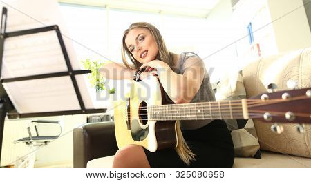 Beautiful Woman Guitarist Home Musical Lesson. Girl Performer At Tutorial. Attractive Female Musicia