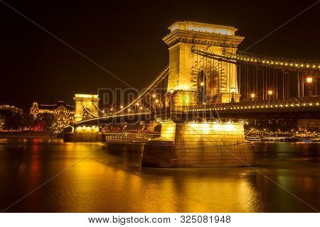 The Famous Széchenyi Chain Bridge In Budapest, Hungary, Illuminated Above The Danube River. Long Exp