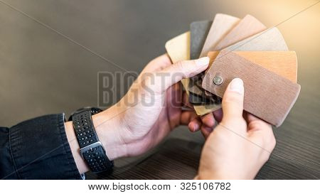 Male Architect Or Interior Designer Hand Holding Wooden Color Swatch Choosing Wood Material For Hous