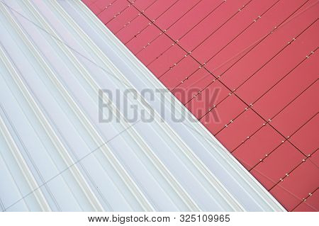 Junction Of Two Materials: Red Metal Rightangled Tiles And White Metal Corrugated Sheet