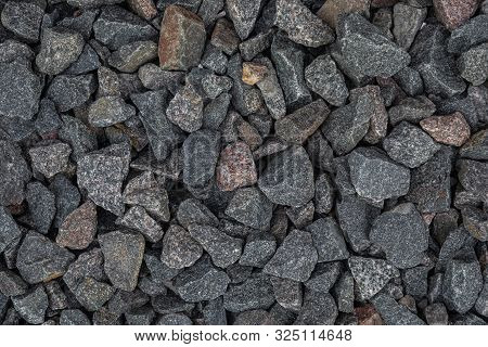 Closeup Of Dark Gravel Laying On The Street