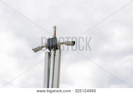 White Security Camera In City. Outdoors Cctv Security Surveillance. Urban Security System, Eye Lens.