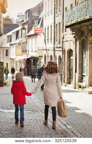 Happy Mother And Daughter At The City