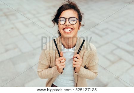 Outdoors Horizontal Portrait Of Young Woman Smiling Broadly With Toothy Smile, With Backpack On The 