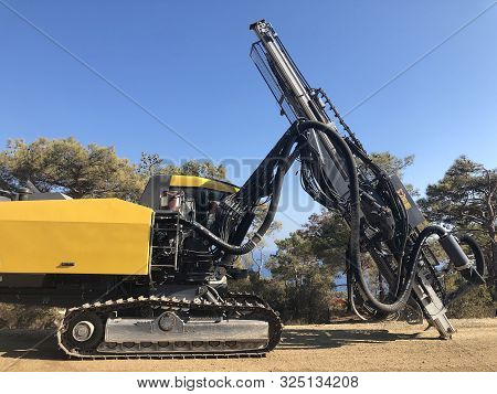 Yellow Machinery For Drilling Holes During Blasthole Drilling Operations. Earthmoving, Excavations,