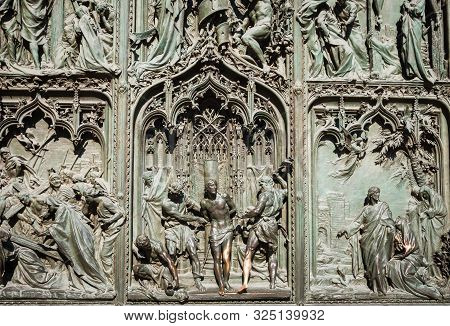 Ornate Detail Of The Bronze Door Of Milan Catehdral In Italy