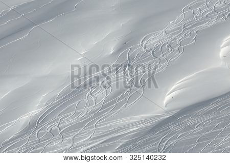 Skiers' and snowboarder's curves in the snow