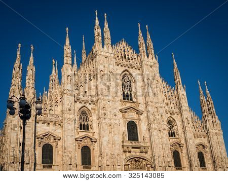 Ornate Facade Of Milan Catehdral In Italy At Sunset