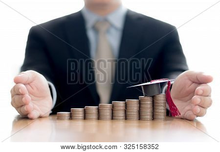 A Businessman Saveing Coins For Eudcation Concept