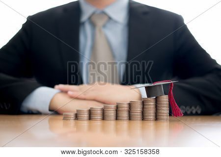 A Businessman Saveing Coin For Eudcation Concept