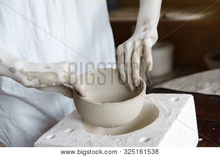 Female Hands Hold A Bowl For Casting Clay Products