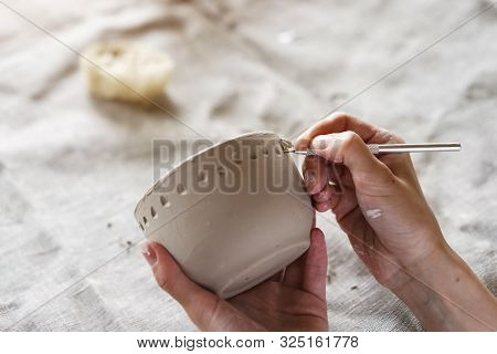 Female Hands Hold A Bowl For Casting Clay Products