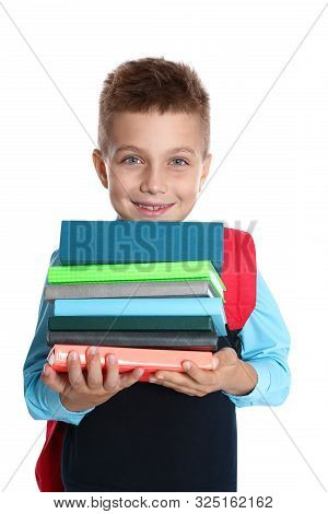 Happy Boy In School Uniform With Stack Of Books On White Background