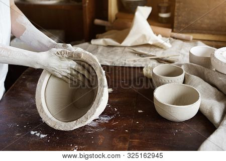 Female Hands Hold A Bowl For Casting Clay Products.