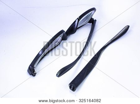 Image Of A Broken Eyeglass Or Spectacle Or Reading Glass Frame With White Background
