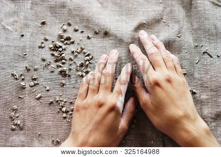 Female Hands In A Wet Clay. Pottery Making. Linen Fabric.