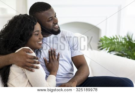 Happy Family. Closeup Portrait Of Smiling Africam American Couple Cuddling At Home, Copy Space