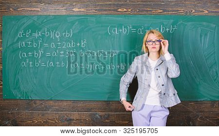 Preparing To The Exams. Teacher On School Lesson At Blackboard. Woman In Classroom. Study And Educat