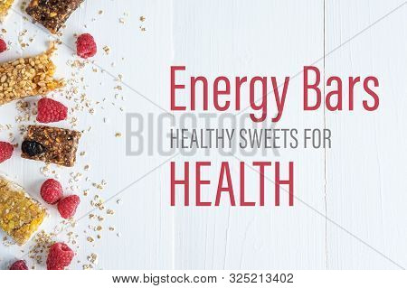 Energy Bars Healthy Sweets For Health. The Inscription On A White Wooden Background With Granola And