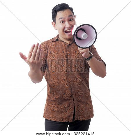 Young Asian Businessman Wearing Batik Using Megaphone, Promoting Gesture. Close Up Body Portrait. Is