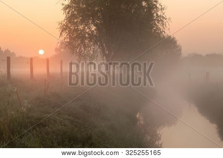 Sunrise By The  Creek At A Foggy Morning In Menen, Belgium