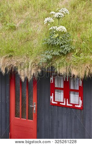 Traditional Faroe House With Grass Roof And Black Wooden Facade