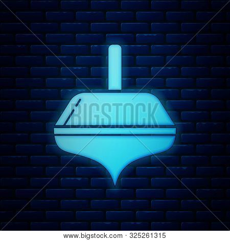 Glowing Neon Hanukkah Dreidel Icon Isolated On Brick Wall Background. Vector Illustration