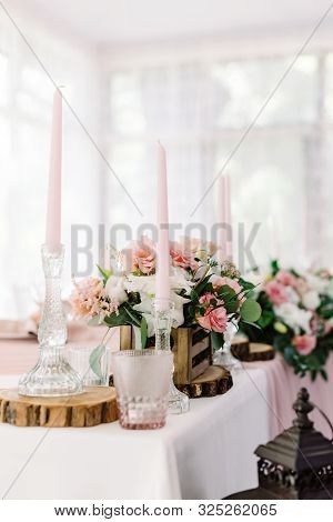 Wedding Decor In Gentle Shades And Natural Materials. Pale Pink Candles In Tall Glass Candlesticks
