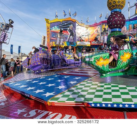 Munich, Germany, 2019 September 28: Visitors Enjoy On An Amusement Park Ride. Breakdancer Fun Ride, 