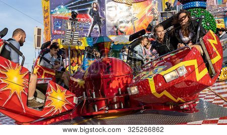 Munich, Germany, 2019 September 28: Visitors Enjoy On An Amusement Park Ride. Breakdancer Fun Ride, 