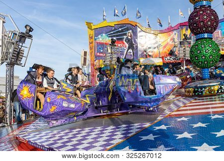 Munich, Germany, 2019 September 28: Visitors Enjoy On An Amusement Park Ride. Breakdancer Fun Ride, 
