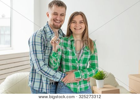 Young Married Couple With Boxes And Holding Flat Keys.
