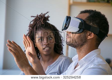 Multiethnic Developers Testing Vr Simulator Together. Young Woman Watching Her Male Colleague Wearin