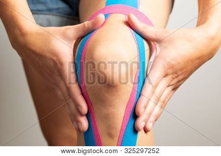 Kinesiotaping, Kinesiology. Female Athlete With Kinesiotape, Muscle Tape On Knee