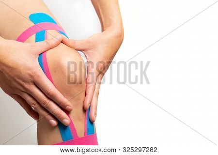 Kinesiotaping, Kinesiology. Female Athlete With Kinesiotape, Muscle Tape On Knee
