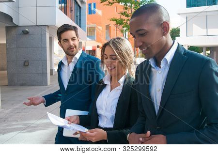 Satisfied Business Colleagues Discussing Project On Their Way To Office. Business Men And Woman Walk
