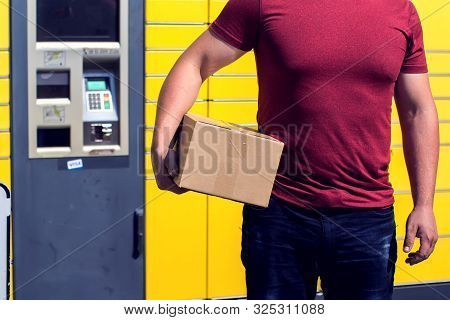 Man Client Received A Parcel Using Automated Self-service Post Terminal Machine Or Locker