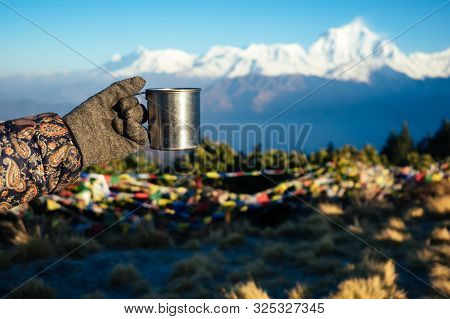 A Metal Cup With A Hot Drink In The Hand Against The Background Of The Mountains. The Concept Of An 