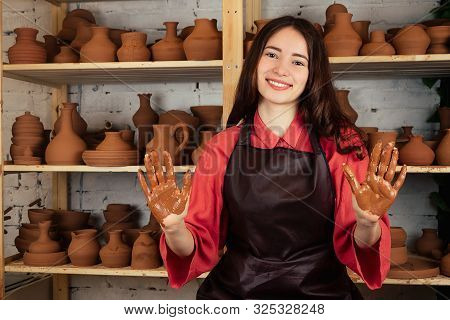 A Beautiful Potter Girl Works With Clay And Makes A Pot Of Mastre. A Woman Works With Clay On A Pott